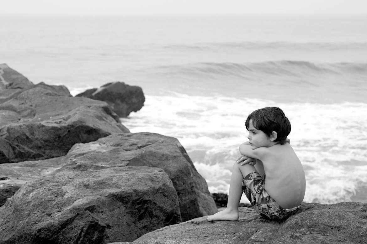 black and white photo of boy looking out at sea, newport beach, ca photographed by Scott Gilbertson